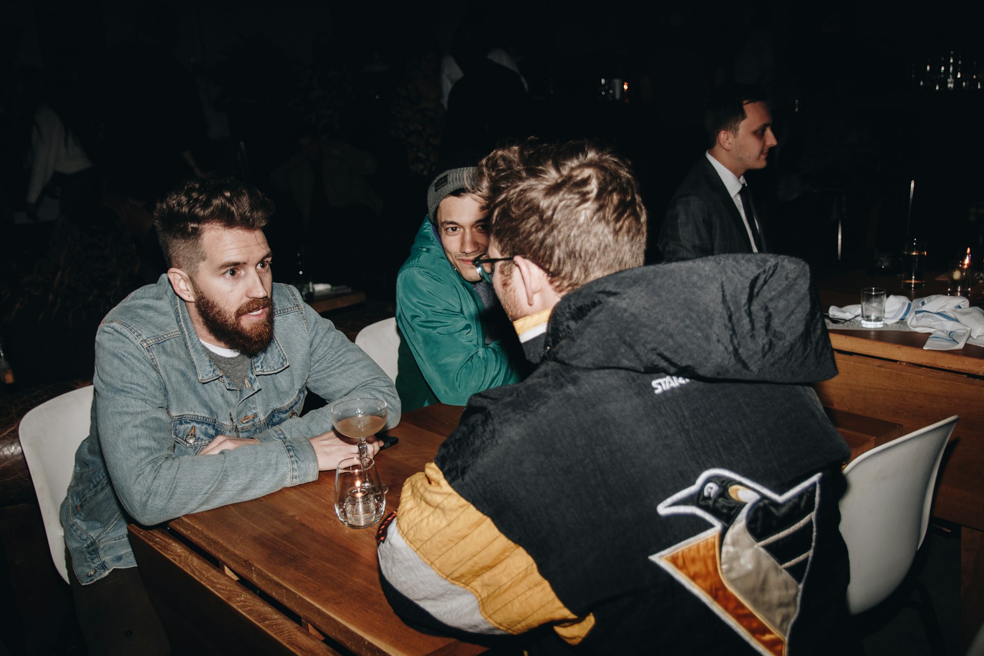 A group of people sitting around a wooden table